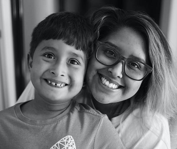 a woman and a boy are posing for a picture